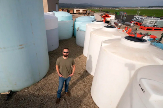 William Terry, of Terry Farms, poses among fertilizer tanks at his farm Thursday, March 31, 2022, in Oxnard, Calif. Terry Farms, which grows produce on 2,100 acres largely, has seen prices of some fertilizer formulations double; others are up 20%. Photo: AP