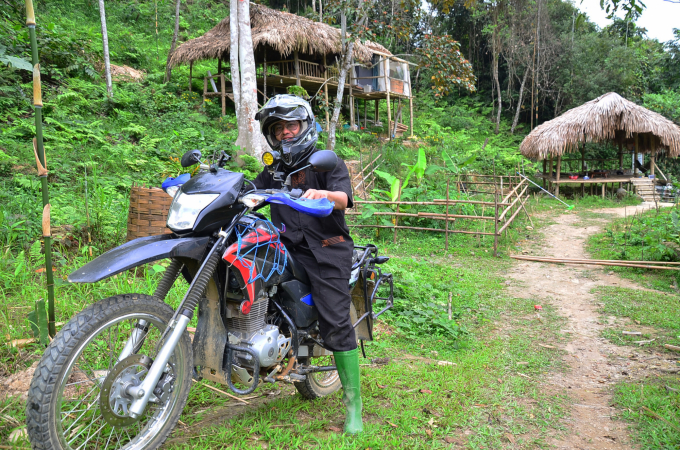 Hoang Quoc Thanh 'the great doctor' next to his huts in the middle of the forest. Photo: Duong Dinh Tuong.