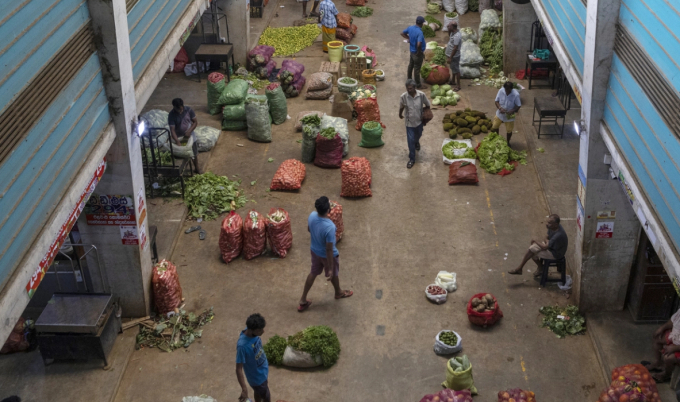 Customers browse vegetable stalls at the wholesale market in Colombo, Sri Lanka, on Wednesday, July 27, 2022