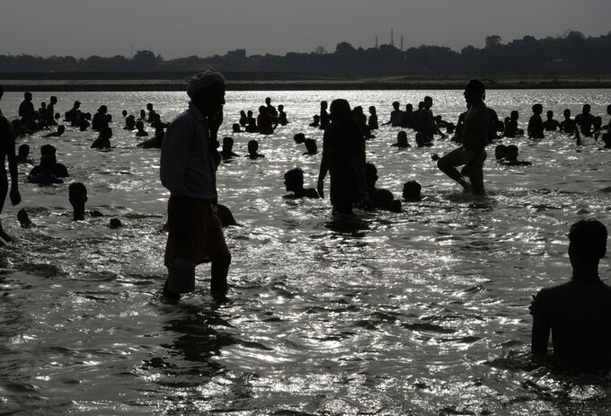 People bathe in the river Ganges to cool themselves off as northern Indian continues to reel under intense heat wave in June 2022. Kim Stanley Robinson says he is still optimistic, 'if you you think of optimism as pessimism of the intellect, optimism of the will'.