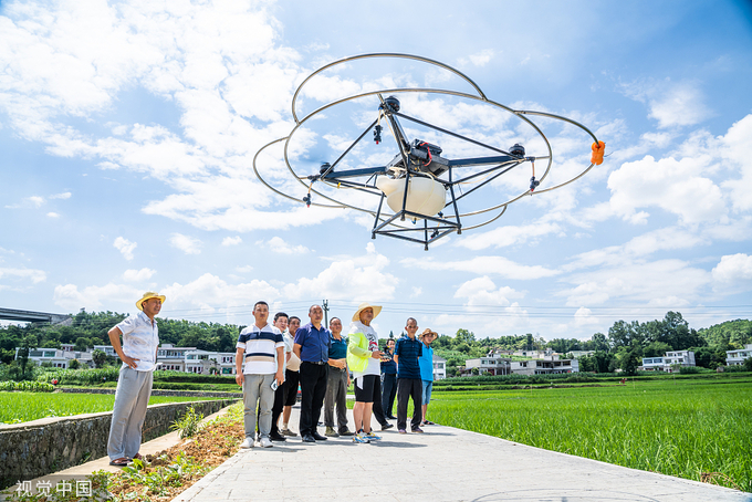 Technicians operate a drone to check a farm in Bijie, Southwest China's Guizhou province, on June 30, 2022. Photo: VCG