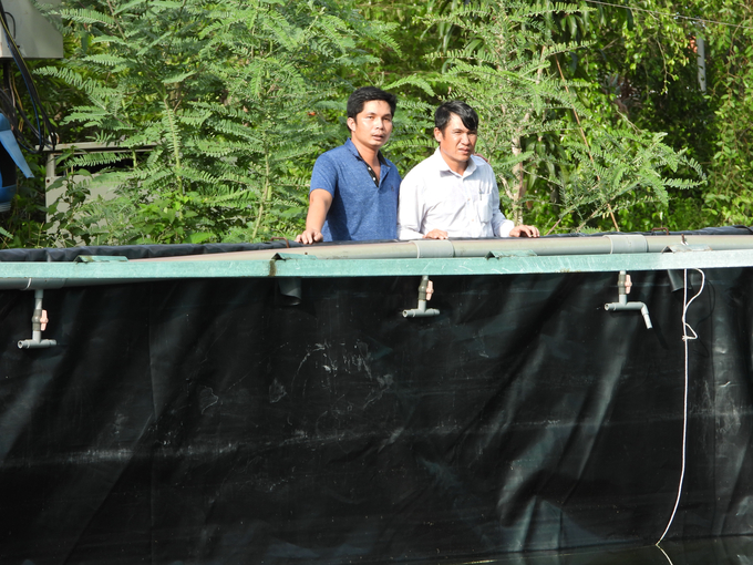 Cán bộ Phòng NN-PTNT huyện thăm, kiểm tra mô hình nuôi tôm của anh Trần Quốc Việt (áo trắng). Ảnh: Trần Trung.