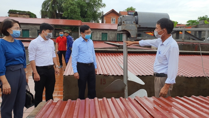 Deputy Diretor of the Department of Agriculture inspecting a sardines processing facility.