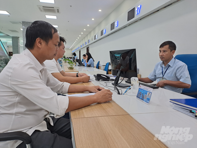 Cán bộ tại bộ phận hành chính công Sở NN-PTNT Quảng Ninh hướng dẫn người dân thực hiện thủ tục hành chính tại Trung tâm hành chính công tỉnh. Ảnh: Viết Cường.