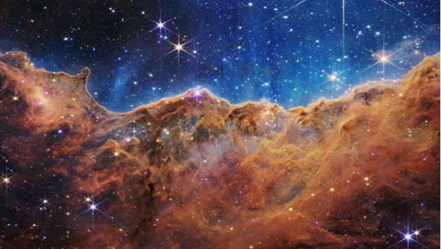 This image released by NASA on Tuesday, July 12, 2022, shows the edge of a nearby, young, star-forming region NGC 3324 in the Carina Nebula. Captured in infrared light by the Near-Infrared Camera (NIRCam) on the James Webb Space Telescope, this image reveals previously obscured areas of star birth, according to NASA. Photo: NASA, ESA, CSA, and STScI via AP