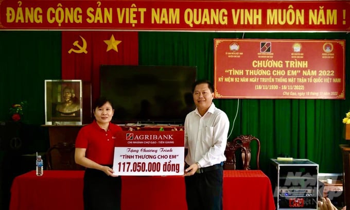 Công đoàn cơ sở ngân hàng Agribank Chợ Gạo, tỉnh Tiền Giang trao tặng tượng trưng số tiền hỗ trợ cho Chương trình 'Tình thương cho em'. Ảnh: Quốc Trí.