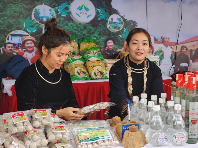 Chị Triệu Thị Thủy và đồng nghiệp giới thiệu sản phẩm đặc trưng của huyện Chợ Đồn cho khách hàng. Ảnh: Đinh Mười.
