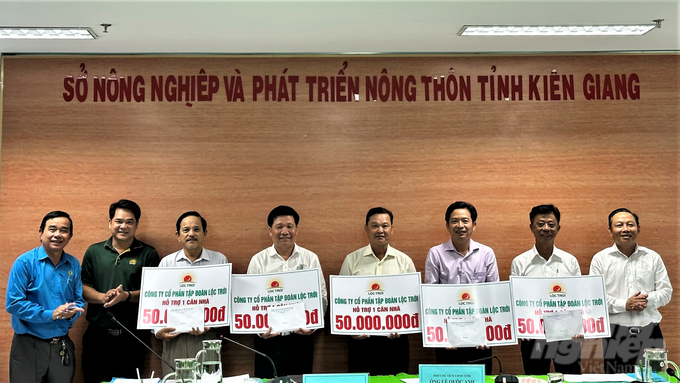 Ông Lê Hữu Toàn (bìa phải), Phó Giám đốc Sở NN-PTNT Kiên Giang trao số tiền 600 triệu đồng do Tập đoàn Lộc Trời tài trợ để hỗ trợ 12 hộ khó khăn về nhà ở xây nhà Đại đoàn kết. Ảnh: Trung Chánh.
