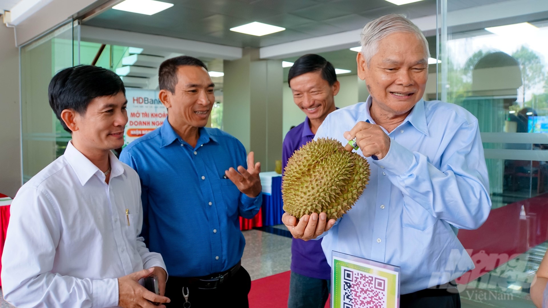 GS Trần Văn Hâu (bìa phải) kiểm tra trái sầu riêng được trồng theo phương pháp hữu cơ tại Đồng Nai. Ảnh: Lê Bình.