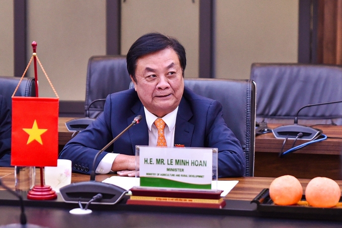 Minister Le Minh Hoan and two oranges he brought back from his visit to the US. Photo: Quynh Chi.