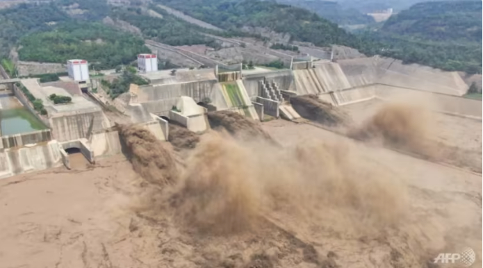 This aerial photo taken on Jul 5, 2021 shows water being released from the Xiaolangdi Reservoir Dam in Luoyang in China's central Henan province. Photo: AFP