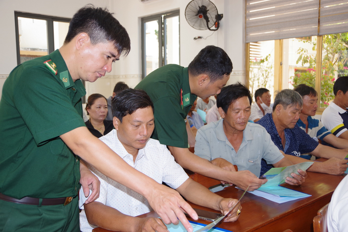 Border guards distribute leaflets to the fishermen of Tam Quan Bac ward (Hoai Nhon town, Binh Dinh). Photo:  V.D.T.