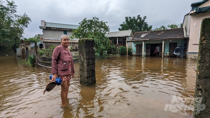 Bà Hồ Thị Bé, vợ ông Dẫn có việc phải ra bên ngoài nhưng nước lụt vẫn còn cao nên chần chừ chưa muốn đi. 
