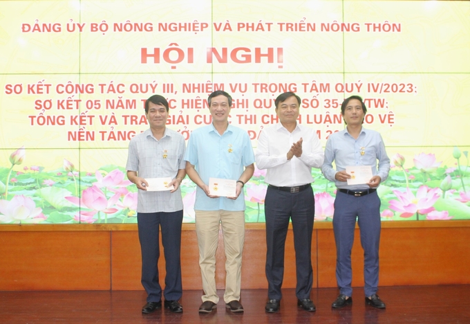 Thứ trưởng Nguyễn Hoàng Hiệp trao tặng Kỷ niệm chương vì sự nghiệp Tuyên giáo cho 3 đồng chí có nhiều thành tích xuất sắc trong công tác tuyên giáo của Đảng. Ảnh: Trung Quân.