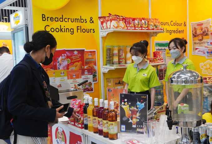 Visitors visit booths displaying food and drinks.