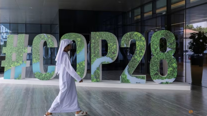 A person walks past a '#COP28' sign during The Changemaker Majlis, a one-day CEO-level thought leadership workshop focused on climate action, in Abu Dhabi, United Arab Emirates on Oct 1, 2023. Photo: Reuters/Amr Alfiky