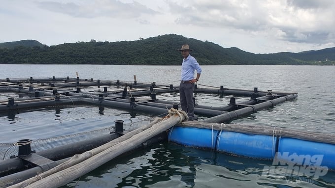 Mr. Tran Nam Chung next to the HDPE plastic aquaculture cages. Photo: Kien Trung.