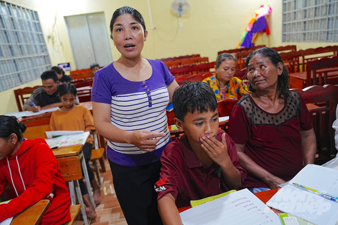 Cô Tạ Thị Hoan bên 2 bà cháu 'học sinh' lớn tuổi nhất lớp. Ảnh: Phúc Lập. 