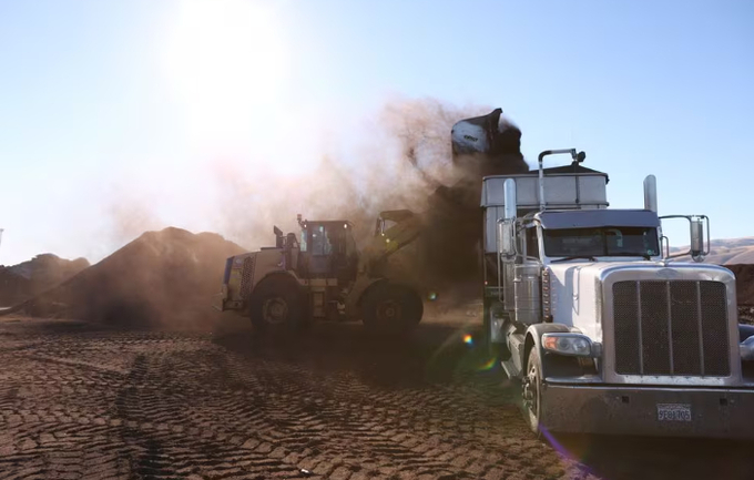 Fresh compost made from food scraps and green waste is loaded onto a truck before being sent to a farm at Recology Blossom Valley Organics North near Vernalis, California, U.S., November 10, 2022.