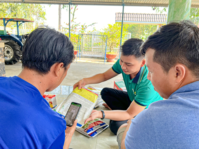 Công ty TNHH Phú Nông hướng dẫn bà con nông dân cách thức quét mã QR trên bao bì sản phẩm để kiểm tra nguồn gốc sản phẩm. Ảnh: Kim Anh.