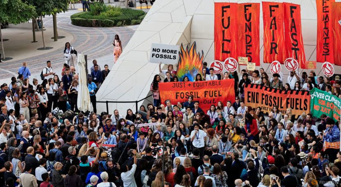 Climate activists protest against fossil fuels during the final stages of the United Nations Climate Change Conference (COP28), in Dubai, United Arab Emirates, on Dec 12, 2023. Photo: Reuters/Thaier Al-Sudani