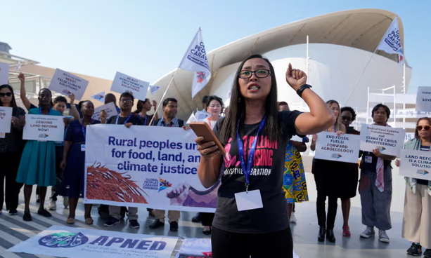 Activists demonstrate for rural people, food, land and climate justice at the Cop28 UN climate summit in Dubai. Photograph: Kamran Jebreili/AP