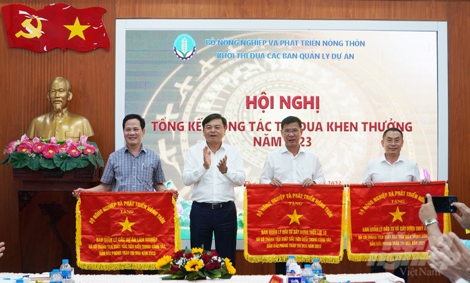 Thứ trưởng Nguyễn Hoàng Hiệp tặng Cờ thi đua của Bộ NN-PTNT cho 3 đơn vị trong khối. Ảnh: Kim Anh.