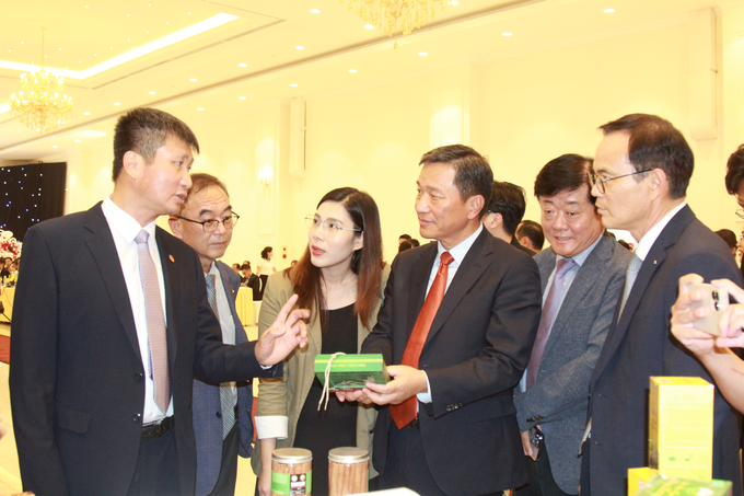 Chủ tịch UBND tỉnh Yên Bái Trần Huy Tuấn giới thiệu gian hàng sản phẩm OCOP của tỉnh với các doanh nghiệp Hàn Quốc. Ảnh: Thanh Tiến.