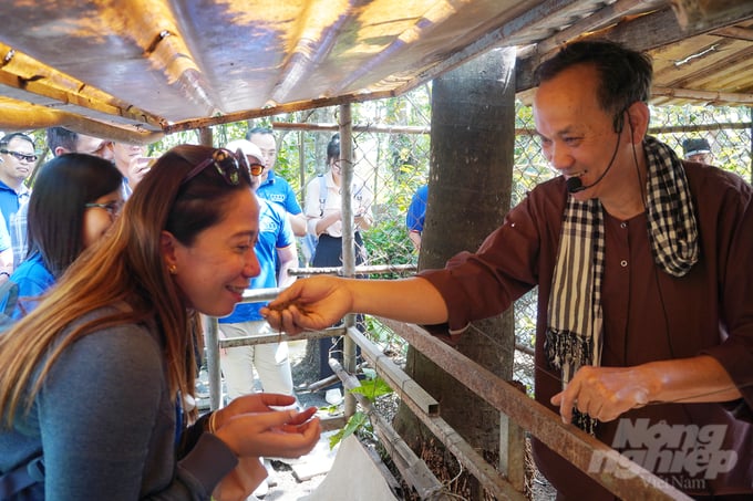 Đoàn khách Philippines ấn tượng với việc phân bón không mùi hôi của vật nuôi tại Nông trại Tam Nông. Ảnh: Nguyễn Thủy.
