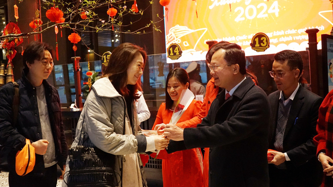 Ông Cao Tường Huy, Chủ tịch UBND tỉnh Quảng Ninh, tặng hoa và lì xì cho đoàn khách Hàn Quốc đến Hạ Long ngày mùng 1 Tết. Ảnh: Nguyễn Thành.
