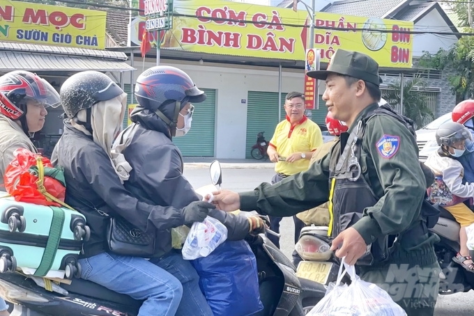 Công an tích cực phát nước suối, khăn lạnh cho người đi đường trở lại với công việc sau Tết Nguyên đán. Ảnh: MV.