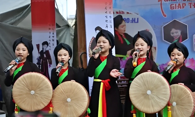 Các em nhỏ tỉnh Bắc Ninh say sưa với điệu hát quan họ quê hương. Ảnh: TTXVN.