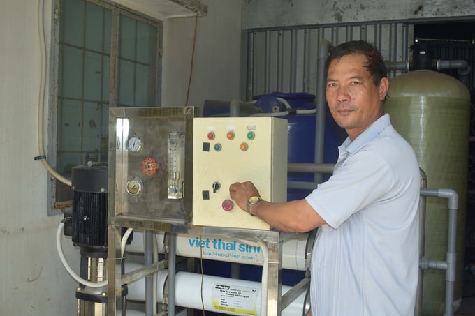 Mr. Tran Van Khoa is operating the R.O salt filtration system to provide free fresh water to local people. Photo: Minh Dam.
