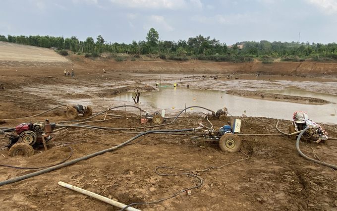 Người dân tại Đắk Mil tranh thủ hút những vũng nước cuối cùng để tưới cho cây trồng. Ảnh: Quang Yên.