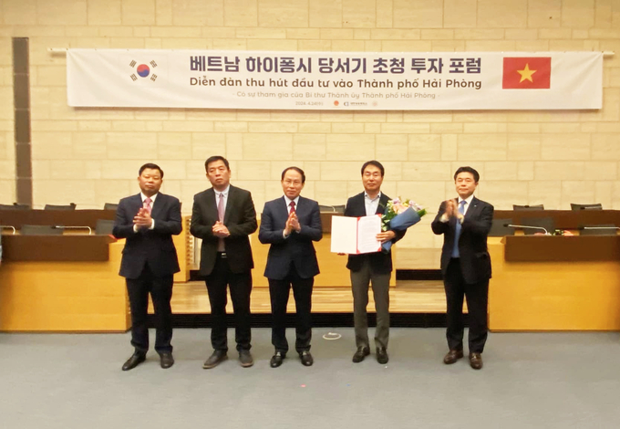 Ông Lê Tiến Châu - Bí thư Thành ủy Hải Phòng trao giấy chứng nhận đầu tư cho một doanh nghiệp Hàn Quốc. Ảnh: Tuấn Mạnh.
