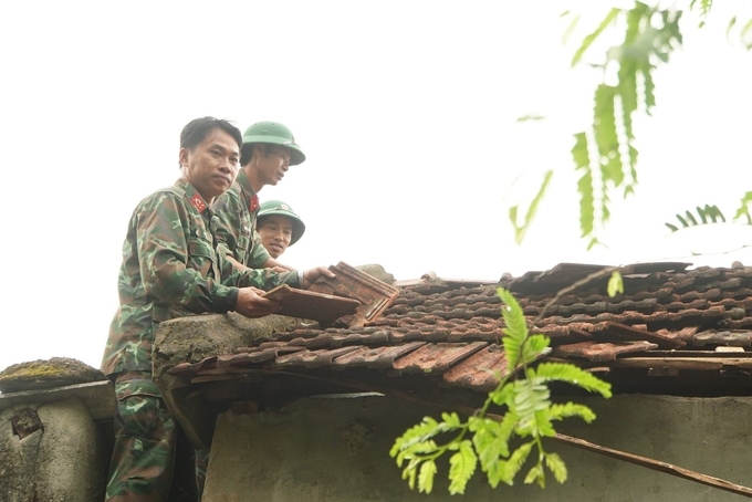 Bộ đội giúp giáo viên và người dân sửa chữa, dọn dẹp nhà cửa, trường học. Ảnh: Phú Lương.