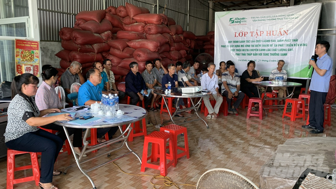 Nông dân chăm chú nghe cán bộ Trung tâm Khuyến nông Quốc gia hướng dẫn quy trình canh tác lúa giảm phát thải. Ảnh: Hồ Thảo.