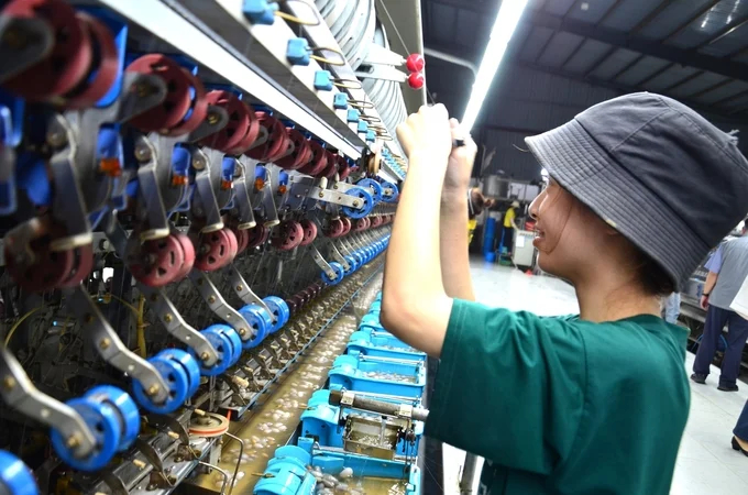 A worker in a silk reeling line. Photo: Duong Dinh Tuong.