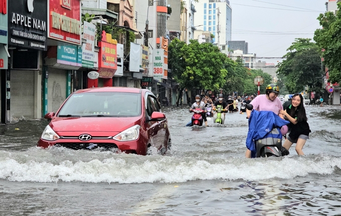 Người đi xe máy 'ăn đủ' mỗi khi ô tô chạy qua. Ảnh: Đinh Mười.