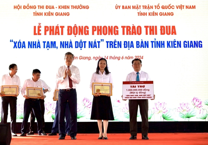 Bà Nguyễn Hồng Thắm, Phó Giám đốc phụ trách điều hành Agribank chi nhánh tỉnh Kiên Giang, trao tặng số tiền 1 tỷ đồng hỗ trợ phong trào 'Xóa nhà tạm, nhà dột nát'. Ảnh: Minh Khương.