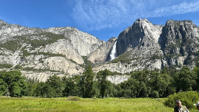 Yosemite National Park with beautiful waterfalls, snow-capped mountains, pine forests and grasslands.
