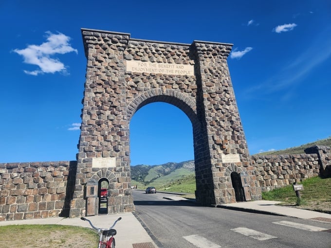The towering entrance gate to Yellowstone National Park has a famous inscription about the goal of serving the people.