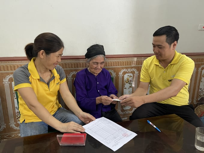 Bà Chu Thị Hỵ (xã Sàn Viên, huyện Lộc Bình, tỉnh Lạng Sơn) vui mừng nhận tiền trợ cấp tuất được nhân viên Bưu điện Việt Nam đem đến chi trả tại nhà. Ảnh: VNP.