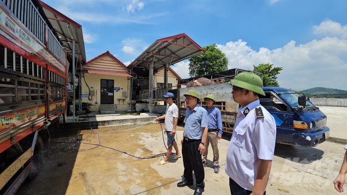 Ông Đặng Văn Hiệp (đứng giữa) cùng cán bộ Chi cục Chăn nuôi và Thú y Thanh Hóa kiểm tra công tác phòng chống dịch bệnh tại Trung tâm bán heo Thanh Hóa. Ảnh: Quốc Toản.