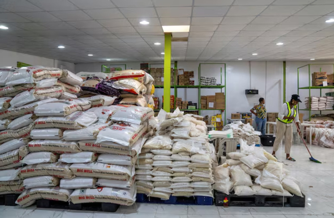 A volunteer sweeps the floor at the Lagos Food Bank warehouse in Lagos, Nigeria, March 23, 2024.