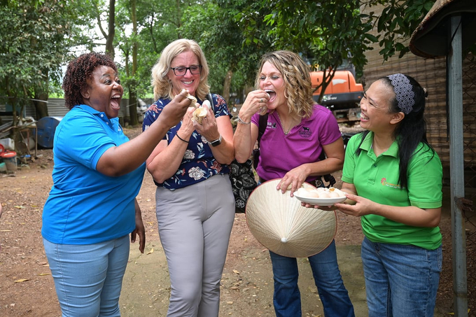 The two American women farmers (center), along with an international delegate (left), were excited to taste boiled eggs and century eggs made from the farm's chicken eggs.