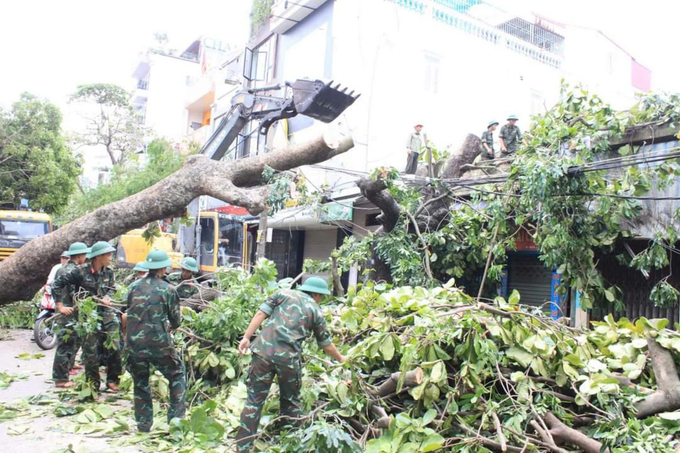 Lực lượng chức năng hỗ trợ dọn cây, nhanh chóng lưu thông đường phố. Ảnh: CTV.