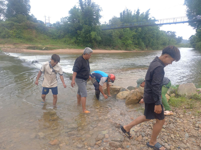 Địa phương huy động người dân tham gia san lấp, gia cố sạt lở để sớm giải phóng ách tắc giao thông. Ảnh: Đ.L. 