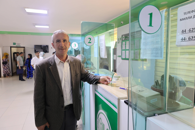 Hasan at a local bank to get his bank statement. Photo: UNDP Tajikistan.