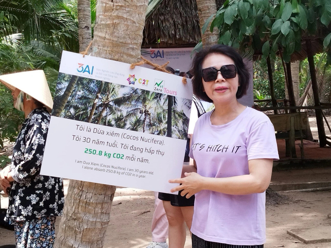 Tourists take souvenir photos with coconut.